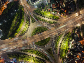 Night aerial shot of Long Bien - Road No. 5 intersection with illuminated highway, light trails and...