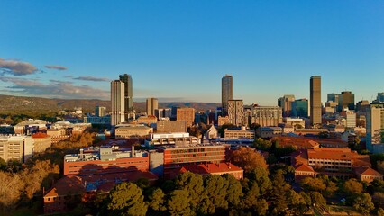 Adelaide CBD, South Australia, June 21, 2025: Aerial Sunset Drone Image Showing Modern Skyline of the City, Skyscrapers, University of Adelaide Campus, Parklands, and Urban Landscape in Golden Light