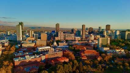 Adelaide CBD, South Australia, June 21, 2025: Aerial Sunset Drone Image Showing Modern Skyline of the City, Skyscrapers, University of Adelaide Campus, Parklands, and Urban Landscape in Golden Light
