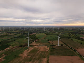 Aerial view of a wind turbine at sunrise, symbolizing renewable energy technology, clean power, sustainability, and environmental awareness.
