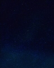 Fototapeta premium Seamless pattern of an elegant starry night illustration showing a cloudless sky and shimmering constellations in rich deep blue gradients