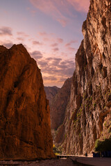 Rocky canyon, people, clear blue sky.