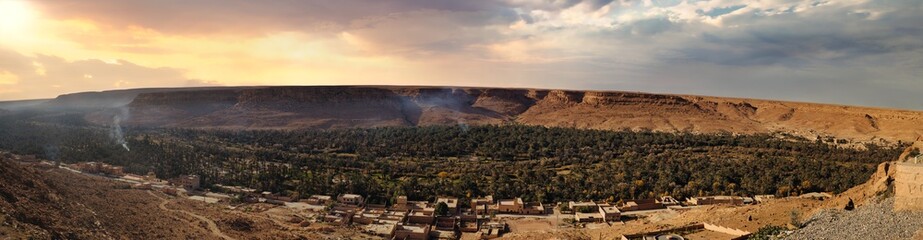 Desert valley, oasis, and buildings.
