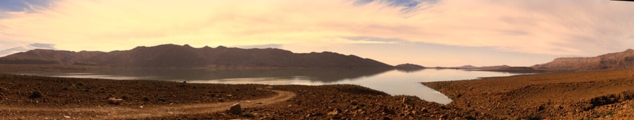 Arid landscape, mountains, and lake.