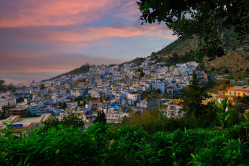 Hillside town, blue and white buildings.