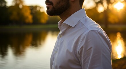 Man in White Shirt Contemplating by a Lake at Sunset