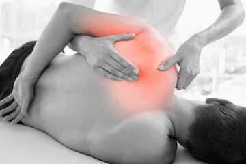 Rear view of injured man having massage