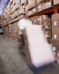 Worker carting cardboard boxes on hand truck