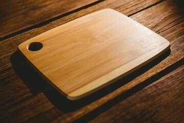 Wooden chopping board on hardwood flooring