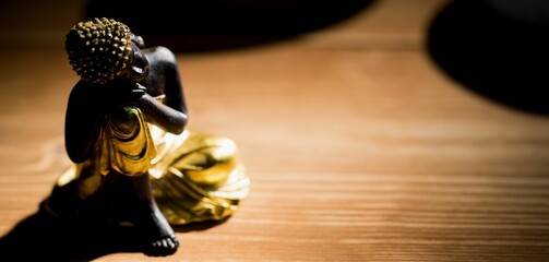 Close-up of statue on wooden floor