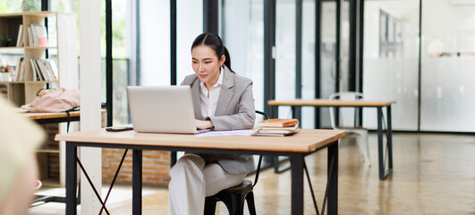 Asian businesswoman Accounting using calculating income-expenditure and analyzing real estate...