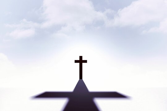 Fototapeta Solitary dark cross standing on white surface in flat design, casting cross shadow under cloudy sky