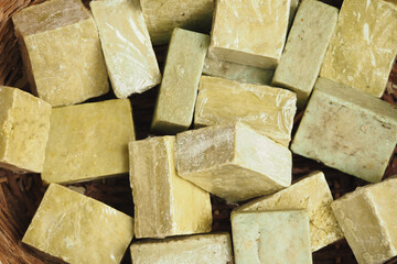 Handmade natural soap bars in a woven basket display