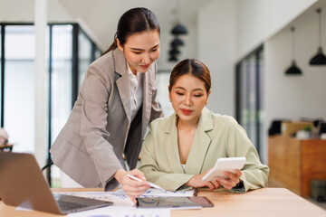 Team of business partnership use calculator to calculate coworkers analysis strategy with...