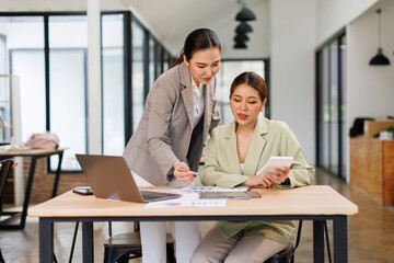 Team of business partnership use calculator to calculate coworkers analysis strategy with...