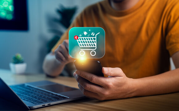 Close-up hand holding smartphone with glowing shopping cart icon and notification badge, symbolizing mobile shopping app, digital e-commerce, online retail, internet purchase, smart consumer behavior
