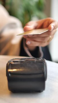 Hand using card reader for payment at a cafe counter