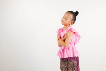Portrait Thailand kid girl smiling traditional Thai dress costume hugging herself remember moment,...