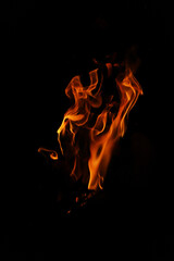 Fire flames on black background. Closeup of fire flames isolated on black background