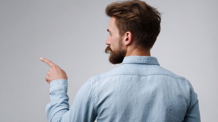 A man with a beard pointing at something
