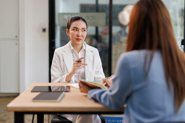 Team of confident business people point to graphs and charts to analyze market data, balance sheet, account, net profit to plan new sales strategies to increase production capacity.	