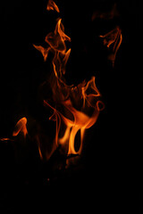 Fototapeta premium Fire flames on black background. Closeup of fire flames isolated on black background
