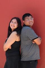 A young couple of 25-year-old dark-skinned Latino men and women embrace and show their youthful love to celebrate Valentine's Day