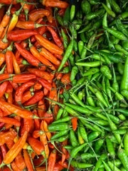 A vivid contrast of red and green chili peppers, showcasing the fiery beauty of freshness and flavor in every vibrant pod.