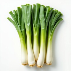 Obraz premium Fresh green leeks arranged on white background