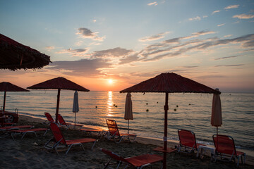  Plaża, parasole, leżaki o wschodzie słońca nad Morzem Egejskim w Paralia Katerini Grecja