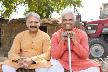 Two pleased senior man discussion at village. 