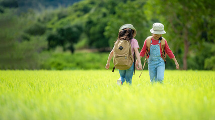 Group family children checking map in the jungle adventure.   Asia people tourism for destination leisure trips for education and relax in nature park.  Mountain background