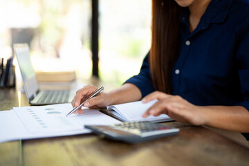 Deduction planning, Close up asian young woman hand using calculator to calculating money balance...