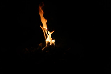 Fire flames on black background. Closeup of fire flames isolated on black background