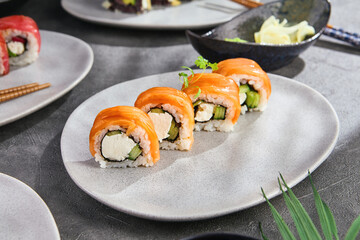 Philadelphia maki with cucumber in bright natural lighting, overhead minimalist composition