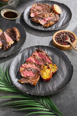 Ribeye steak with grilled potatoes, bright natural lighting, overhead composition
