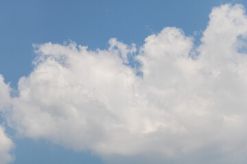 Photo of a clear blue sky with fluffy white clouds