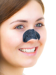Woman applying pore strips on nose