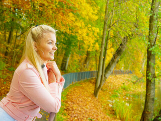 Fashion woman walking in autumn park