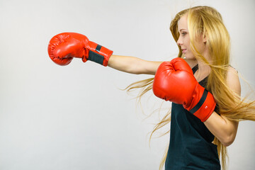Woman in red gloves boxing