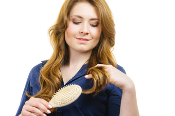 Woman brushing long healthy brown hair