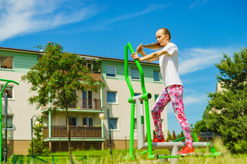 Girl exercise at outdoor gym area