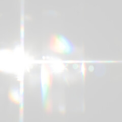 Prominent lens flare with colourful scattered light streaks and reflections on transparent background