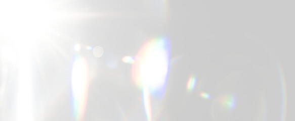 Subtle horizontal lens flare with colourful rainbow refractions, soft circular reflections on transparent background