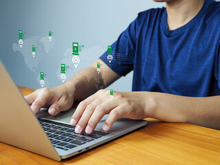 Electric vehicle charging station map concept with person using laptop, showing global locations and digital interface for green energy and technology