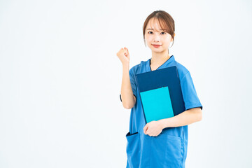 スクラブを着てガッツポーズする女性　看護師　介護士