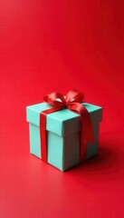 Obraz premium Tiny present box atop red backdrop; close-up view , red, valentines