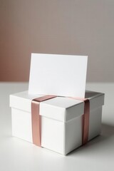 White gift card atop elegant white gift boxes, simple, present