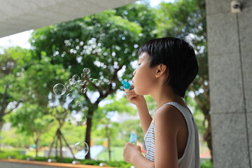 Boy blowing bubbles.