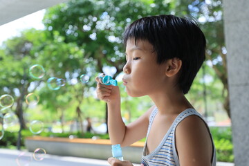 Boy blowing bubbles.